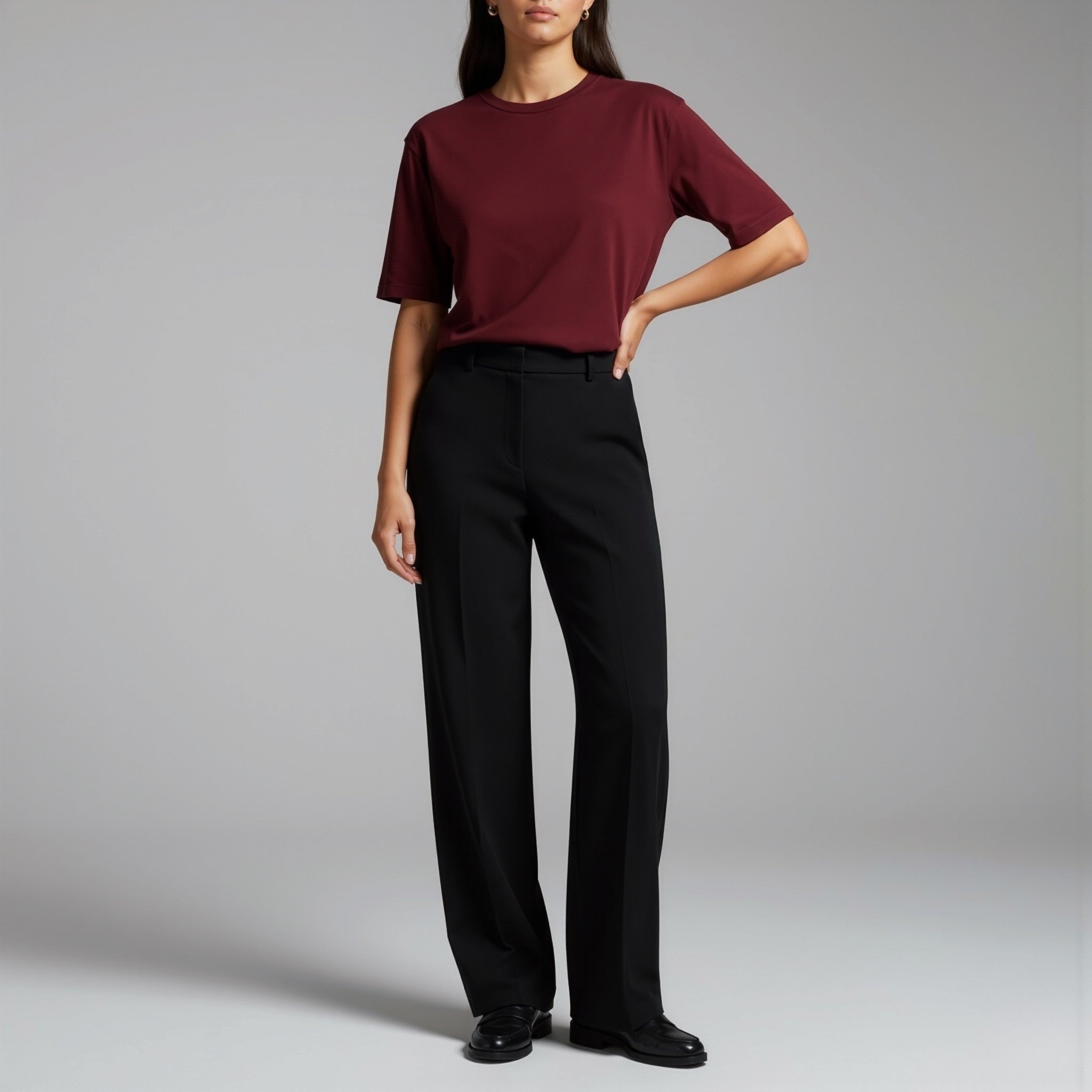 Person wearing a moleculuxe bordeaux burgundy shirt and black pants on a gray background