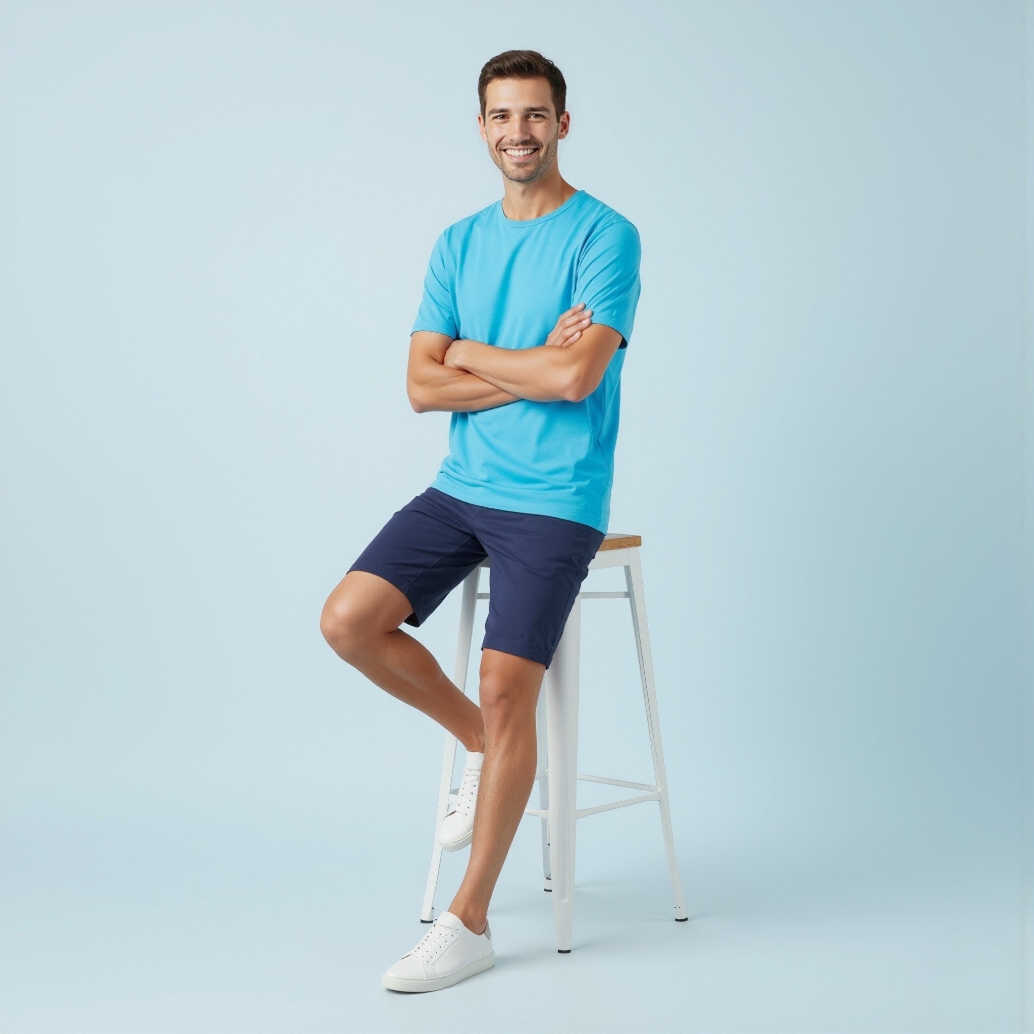 Man wearing a moleculuxe Celestial Blue t-shirt and navy shorts standing on a light blue background
