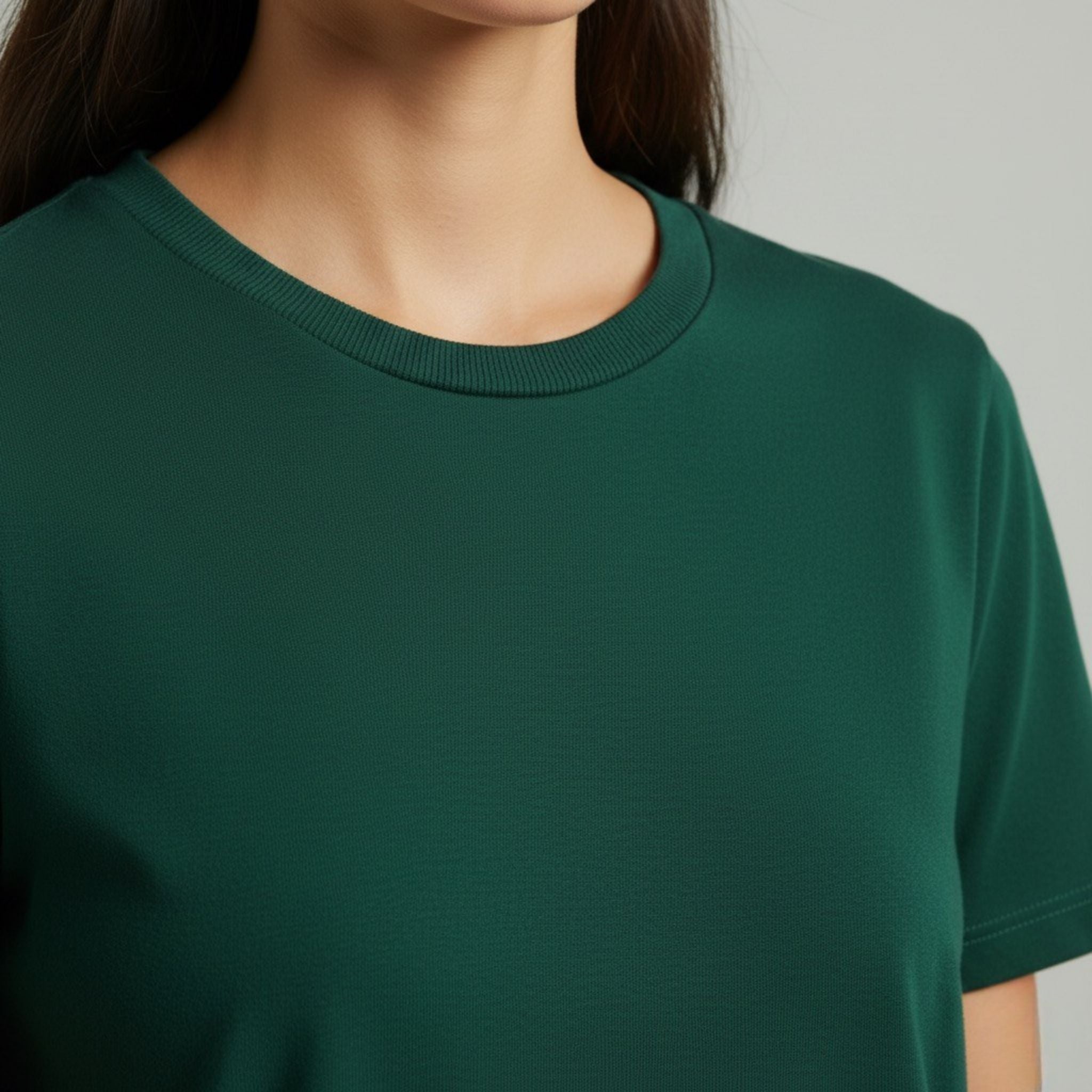 moleculuxe emerald forest Green t-shirt worn by a person on a gray background