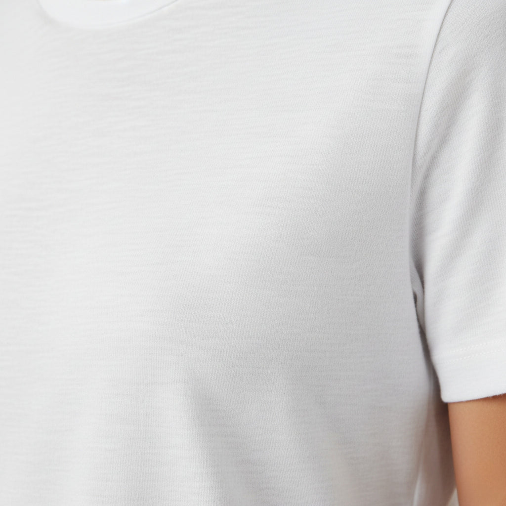 moleculuxe pristine White dress with a close-up of the hem on a light gray background