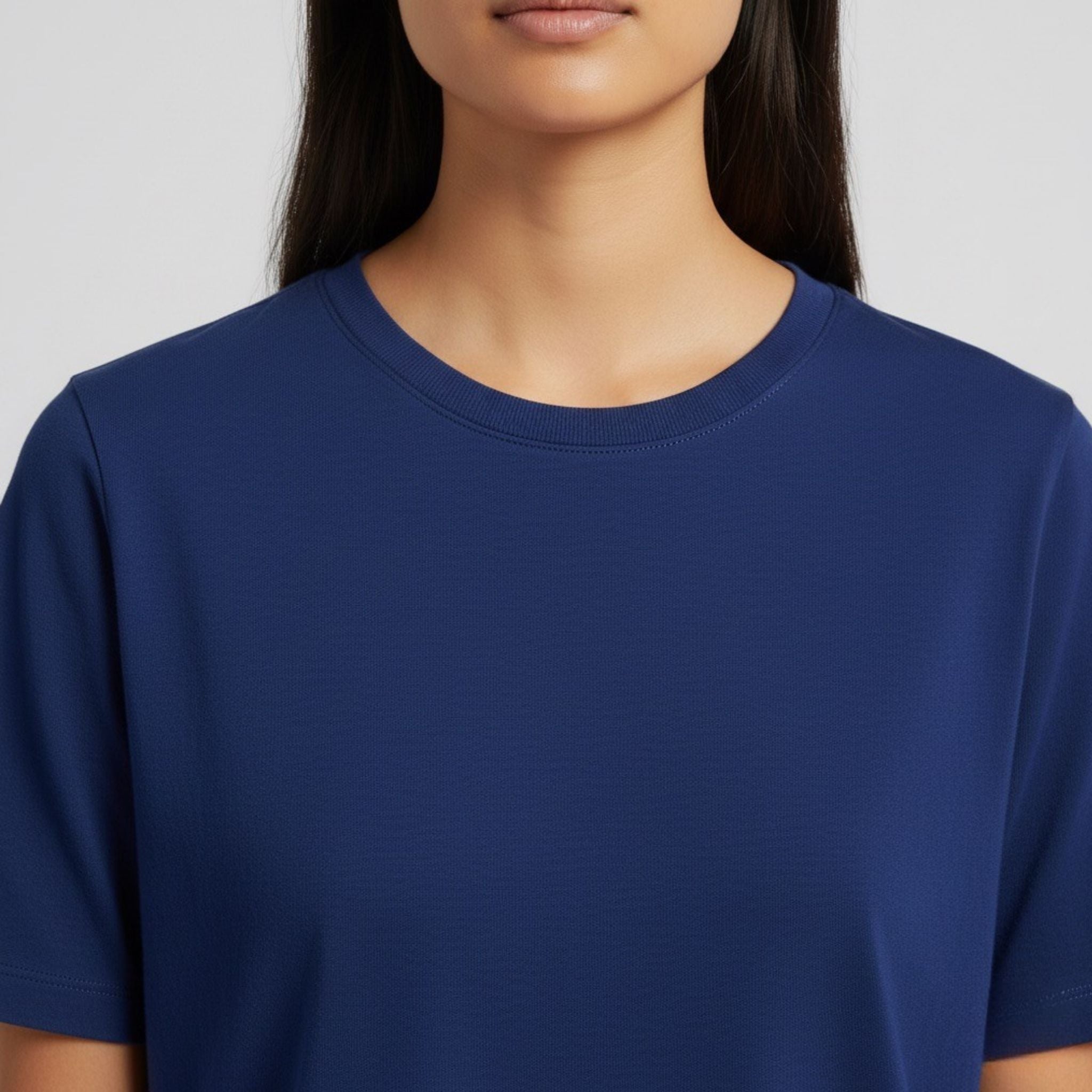 Person wearing a plain moleculuxe Sapphire Majesty blue t-shirt against a neutral background