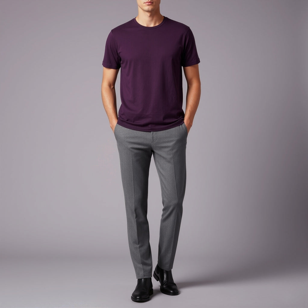 Person wearing a moleculuxe imperial violet purple t-shirt and gray pants on a gray background