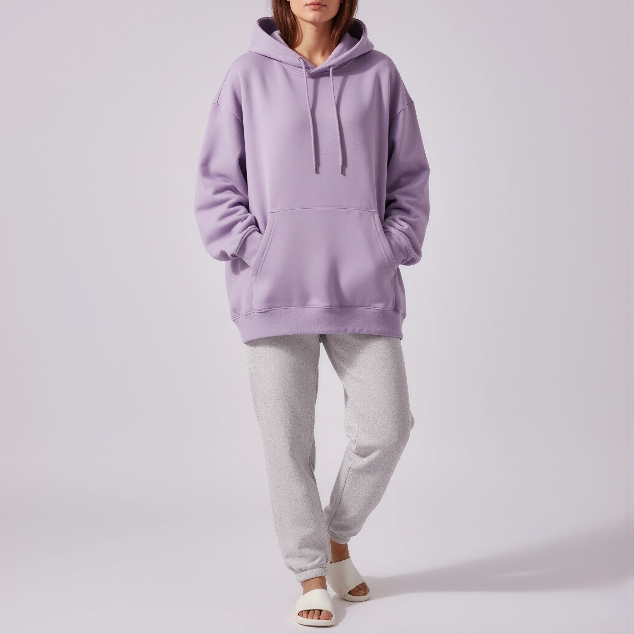 Person wearing a moleculuxe Amethyst Haze lavender hoodie and light gray pants on a white background