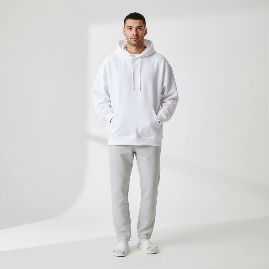 Man wearing a moleculuxe pristine white hoodie and light gray pants on a white background